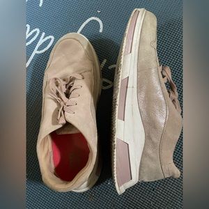 Soft material feels like suede on top. Shiny material as well.  Rubber sole.